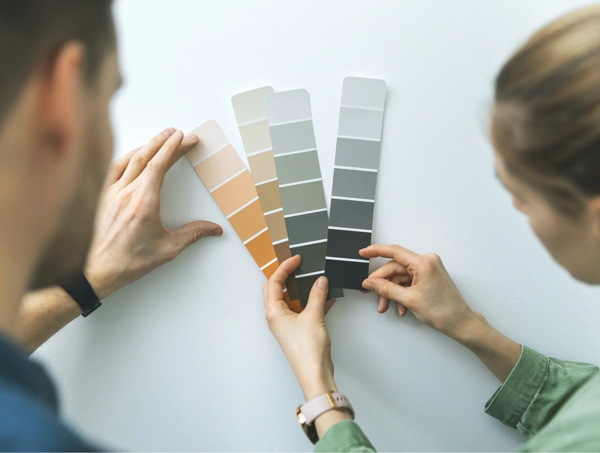 Fanned-out MF Paints colour swatch decks on a counter